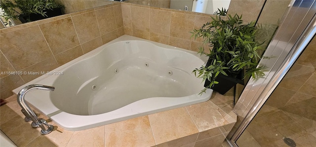 bathroom featuring tiled tub