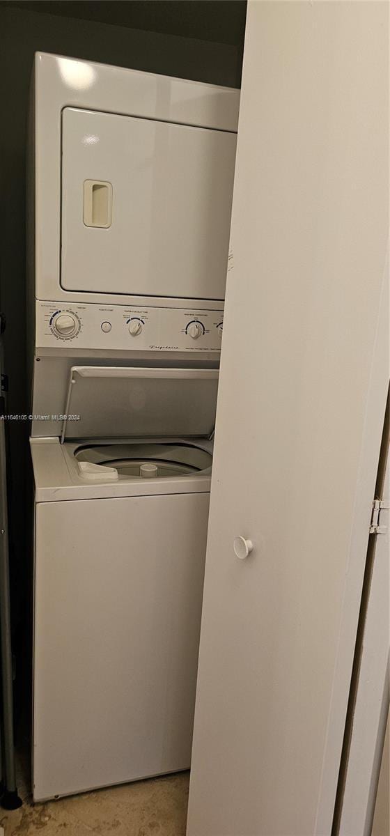 laundry area featuring stacked washing maching and dryer