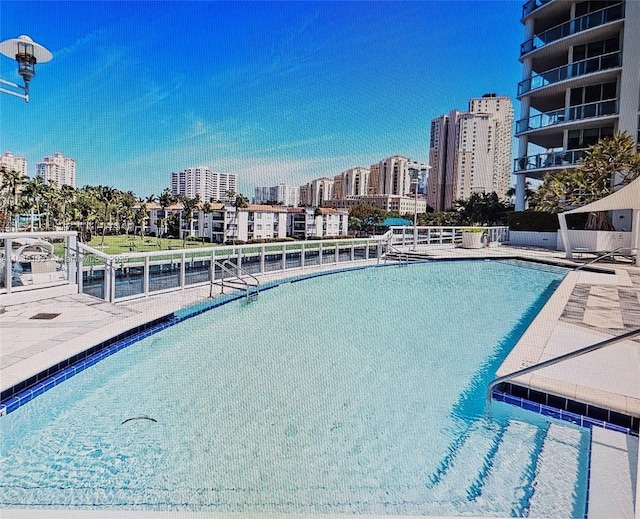 view of pool with a city view