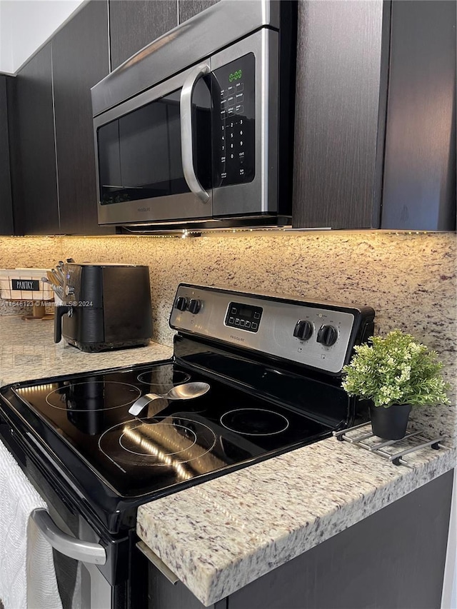 kitchen with appliances with stainless steel finishes and decorative backsplash