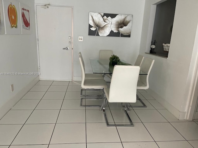 dining area with baseboards and light tile patterned floors