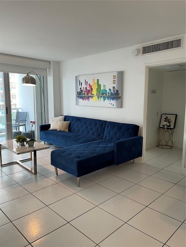 living room featuring tile patterned flooring and visible vents