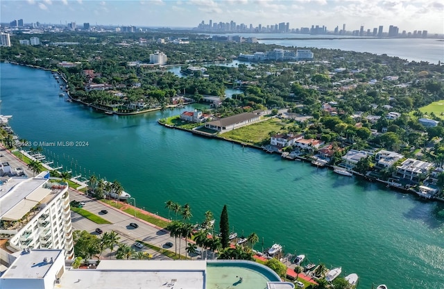 drone / aerial view featuring a city view and a water view