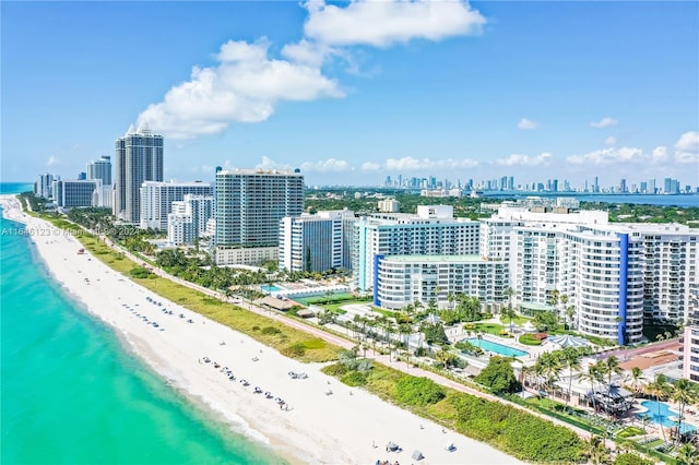 birds eye view of property with a view of the beach, a water view, and a view of city