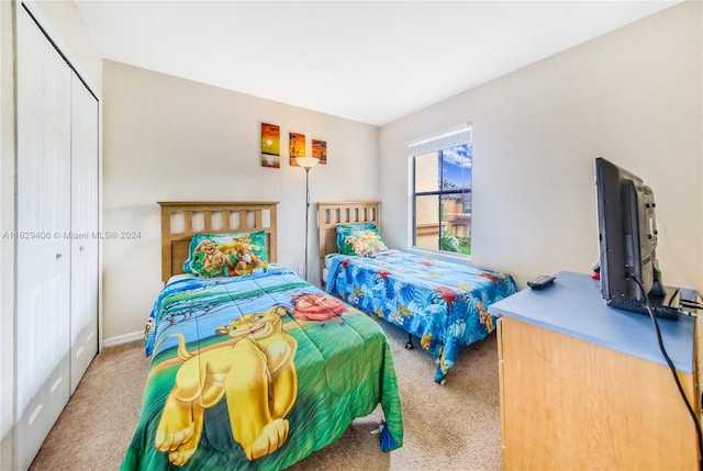 bedroom featuring light colored carpet and a closet