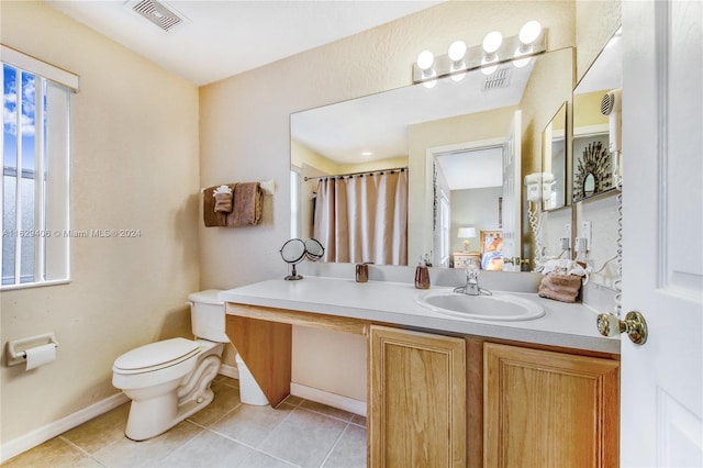 bathroom featuring tile patterned flooring, a shower with shower curtain, vanity, and toilet