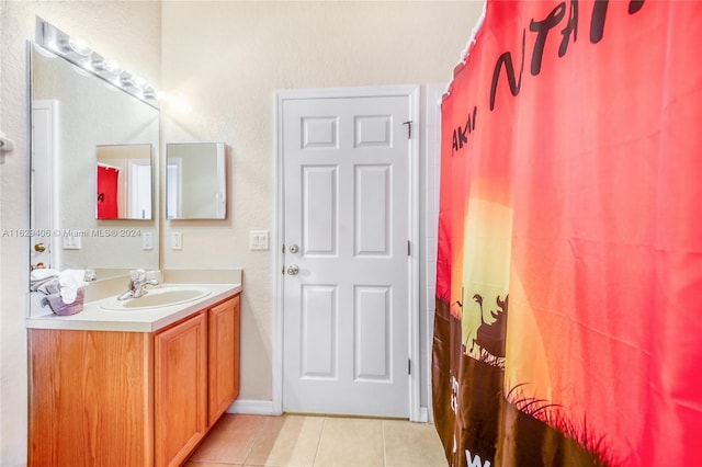 bathroom with tile patterned floors, curtained shower, and vanity