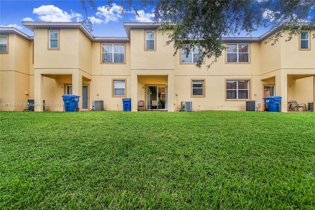 back of property featuring a yard and cooling unit