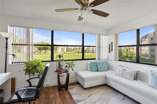 sunroom / solarium featuring ceiling fan and plenty of natural light