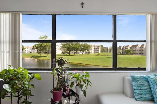 sunroom with a water view and a healthy amount of sunlight