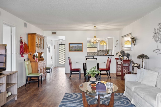 10207 Sunrise Lakes Blvd Unit 203, Sunrise, FL 33322 - living room featuring dark wood-type flooring, a chandelier, and a textured ceiling