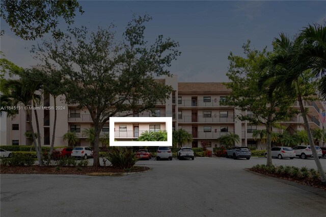 10207 Sunrise Lakes Blvd Unit 203, Sunrise, FL 33322 - view of apartment building / complex featuring uncovered parking
