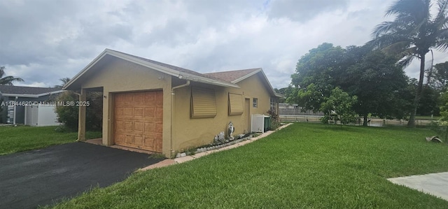 view of property exterior with central AC unit and a yard