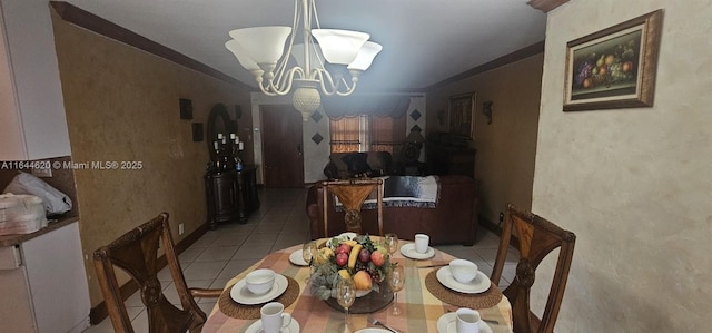 dining space with ornamental molding, tile patterned flooring, and a notable chandelier