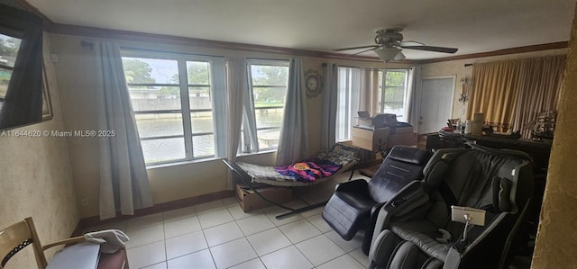 interior space featuring crown molding, ceiling fan, plenty of natural light, and light tile patterned floors