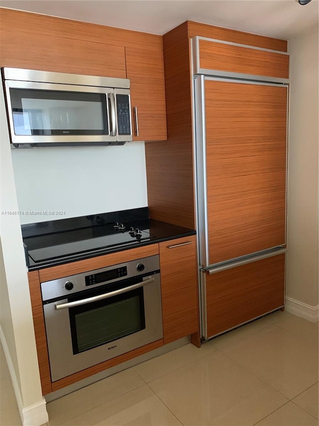 kitchen with appliances with stainless steel finishes and light tile patterned flooring