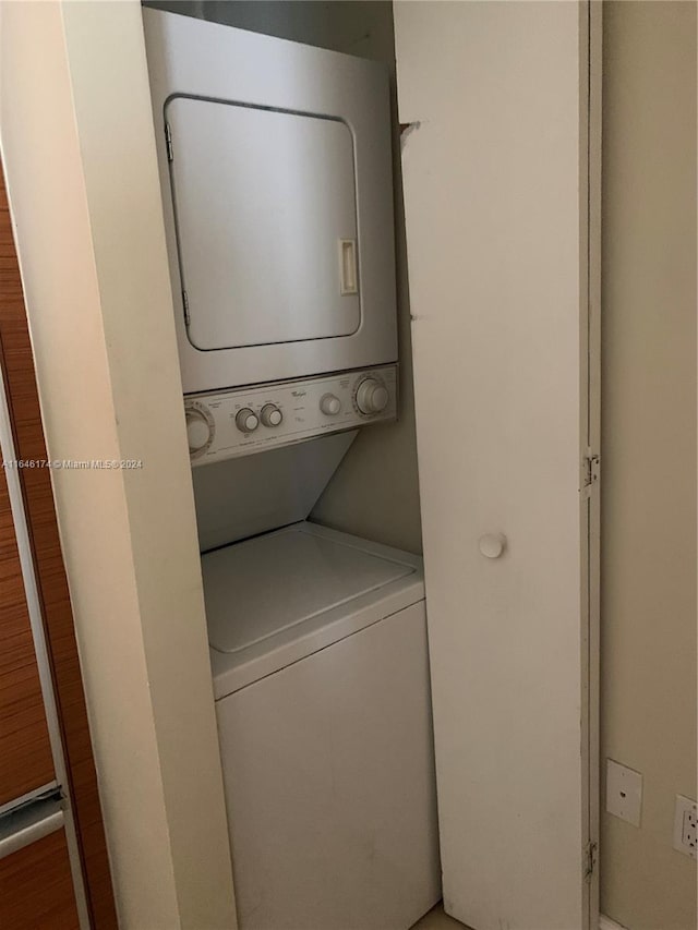 washroom with stacked washer and clothes dryer