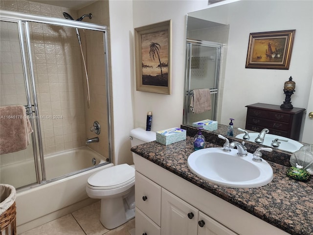 full bathroom featuring shower / bath combination with glass door, tile patterned floors, toilet, and vanity