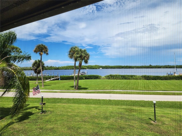 view of property's community featuring a yard and a water view