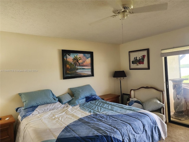 carpeted bedroom with a textured ceiling and ceiling fan