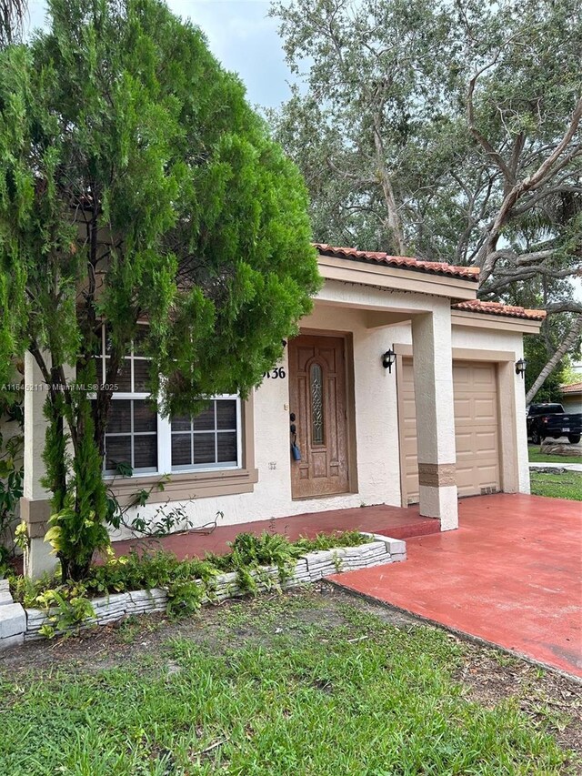 9136 NW 192nd Ter, Hialeah, FL 33018 - view of front of home featuring concrete driveway, stucco siding, and an attached garage