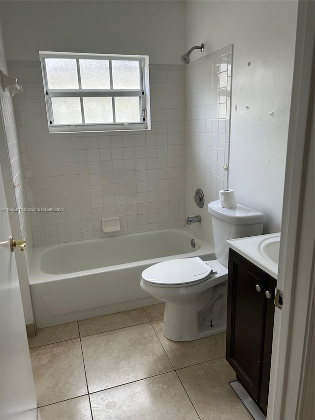 full bathroom featuring tile patterned floors, toilet, vanity, and tiled shower / bath