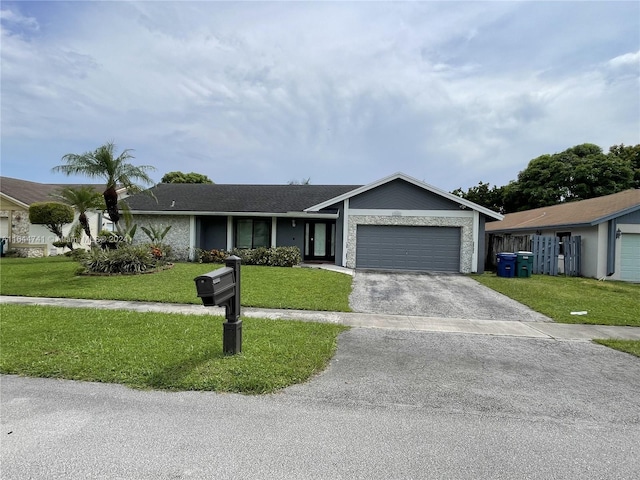 single story home featuring a front lawn and a garage