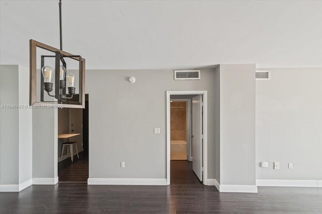 unfurnished room featuring dark hardwood / wood-style flooring