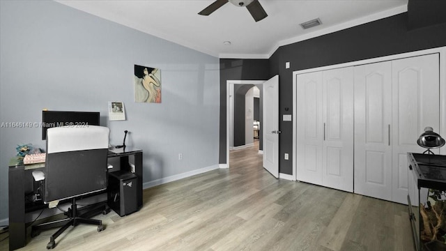 office with light hardwood / wood-style floors, ornamental molding, and ceiling fan