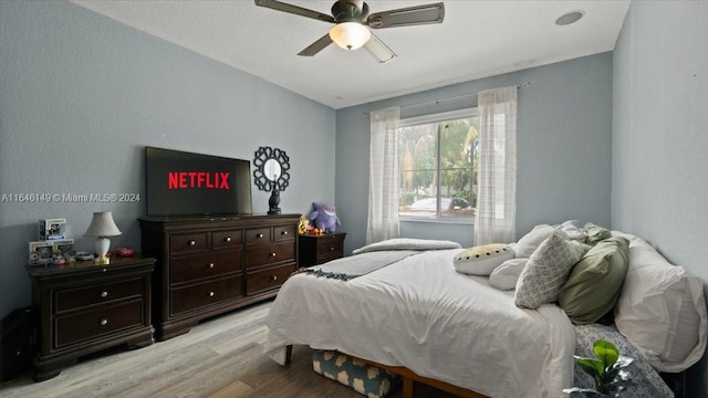 bedroom featuring light hardwood / wood-style floors and ceiling fan