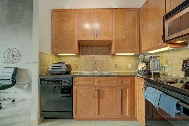 kitchen featuring backsplash, dark stone countertops, light tile patterned flooring, black appliances, and sink