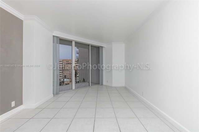 spare room with light tile patterned floors and ornamental molding