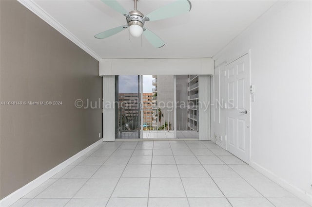 tiled spare room with crown molding and ceiling fan