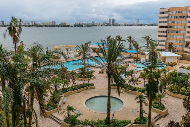 view of swimming pool with a water view and a community hot tub