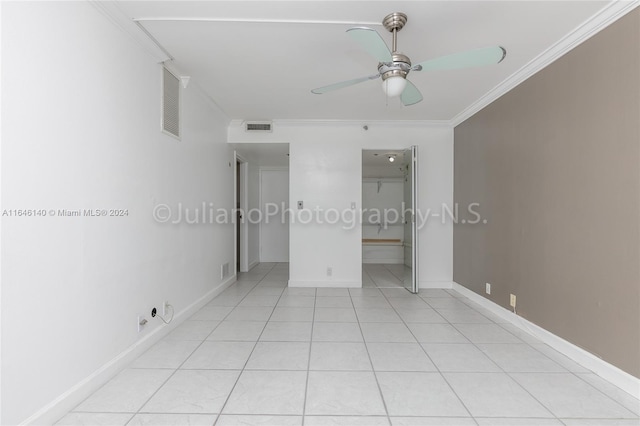 unfurnished bedroom with a closet, ornamental molding, light tile patterned floors, and ceiling fan