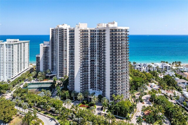 birds eye view of property with a water view and a view of the beach