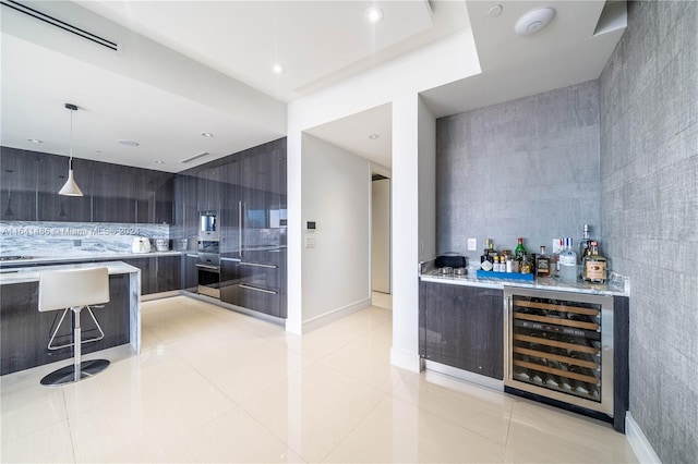 bar with beverage cooler, visible vents, oven, pendant lighting, and light tile patterned flooring