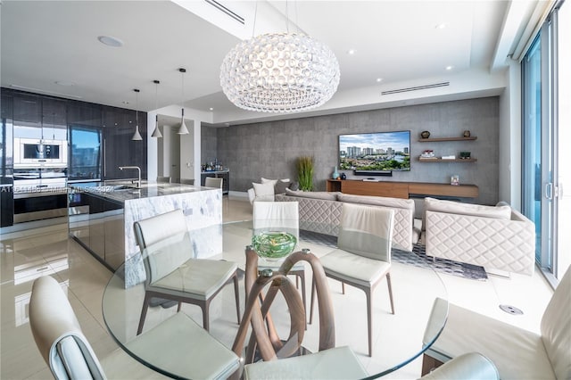 dining space featuring a chandelier, an accent wall, recessed lighting, and light tile patterned floors