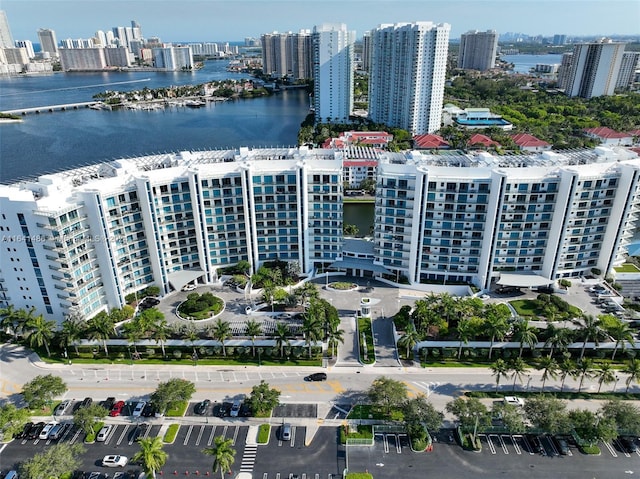 birds eye view of property with a water view and a city view