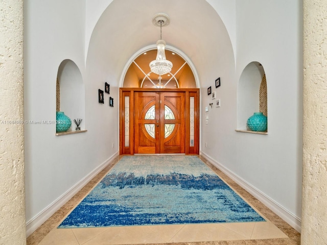175 SW 132nd Ave, Miami, FL 33184 - doorway to outside featuring baseboards, tile patterned floors, and a chandelier