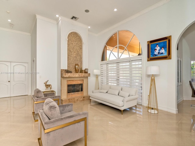 175 SW 132nd Ave, Miami, FL 33184 - living room featuring arched walkways, crown molding, a premium fireplace, recessed lighting, and baseboards