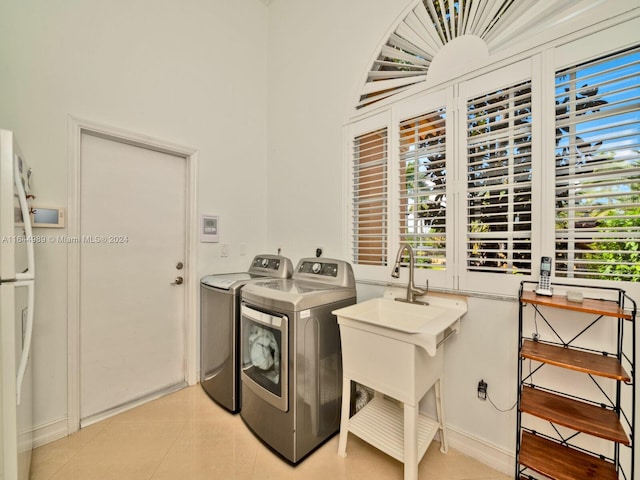 175 SW 132nd Ave, Miami, FL 33184 - laundry area featuring washer and dryer, plenty of natural light, and light tile patterned flooring