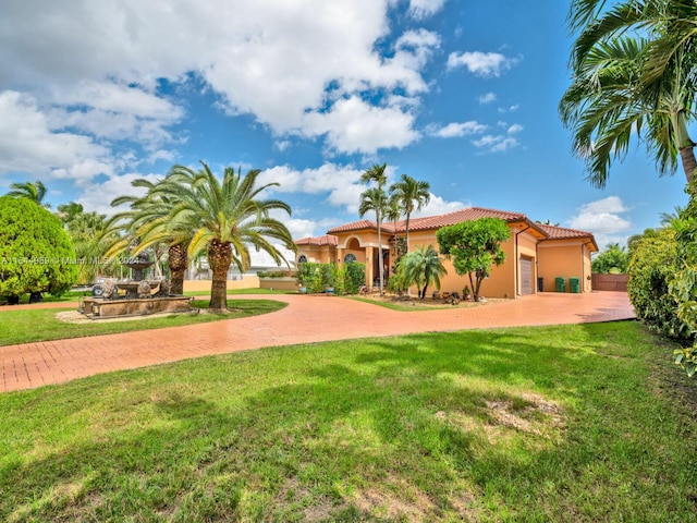 175 SW 132nd Ave, Miami, FL 33184 - mediterranean / spanish home featuring curved driveway, a tiled roof, stucco siding, and a front yard