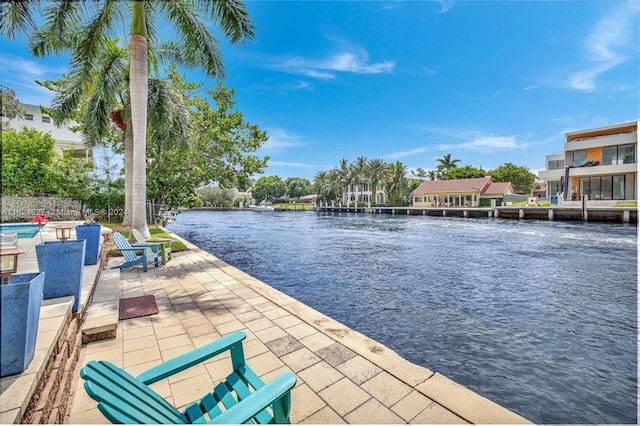 view of dock with a water view and a patio area