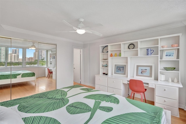 bedroom with ceiling fan, light wood-type flooring, a closet, and ornamental molding