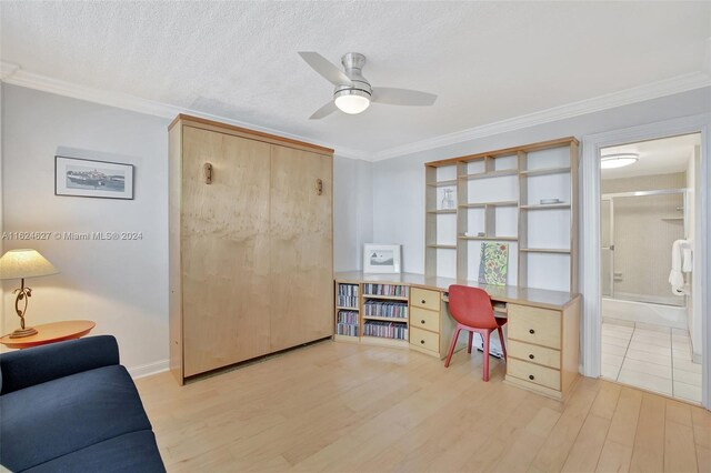 tiled office featuring ceiling fan, ornamental molding, and a textured ceiling