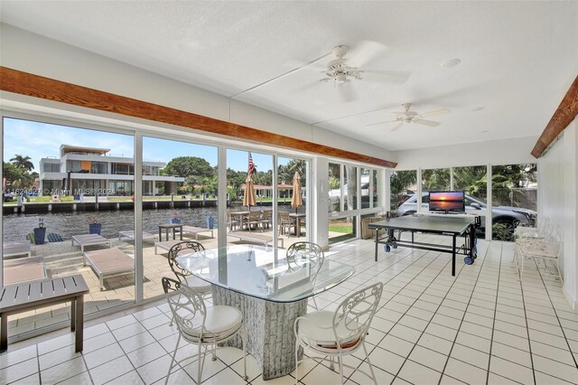 sunroom featuring ceiling fan