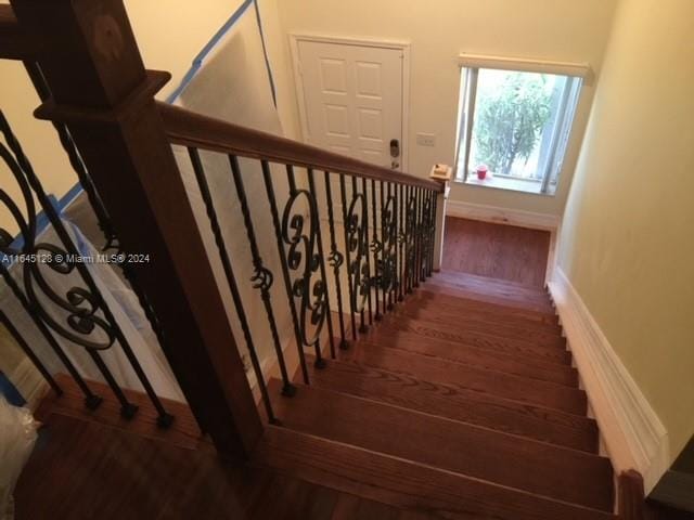 stairs with wood-type flooring