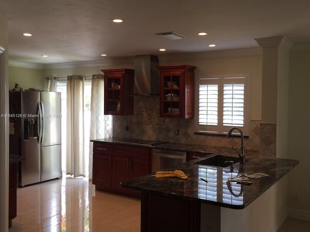 kitchen featuring wall chimney range hood, stainless steel refrigerator with ice dispenser, tasteful backsplash, dishwasher, and sink