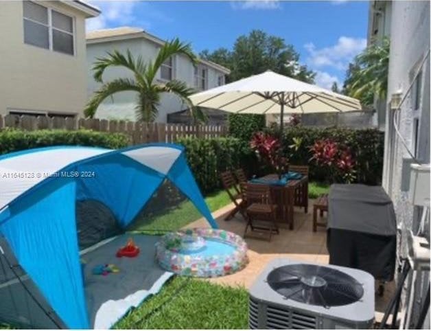 view of swimming pool with a patio and cooling unit